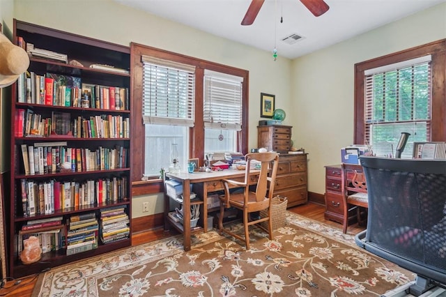 office area featuring wood finished floors, a ceiling fan, and baseboards
