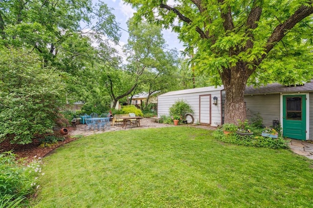 view of grassy yard with a patio