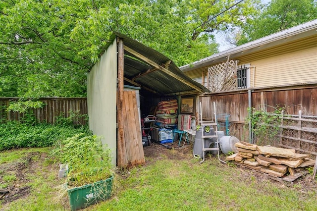 view of outbuilding with fence and an outbuilding