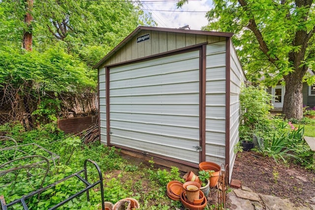 view of outdoor structure featuring an outbuilding and fence