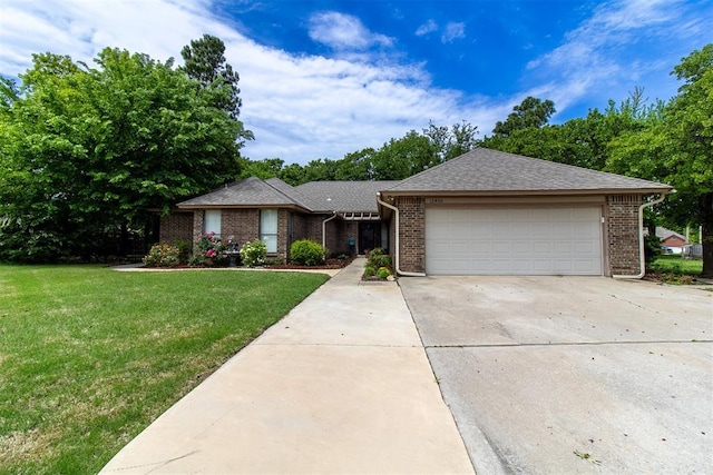 single story home featuring a shingled roof, a front lawn, brick siding, a garage, and driveway