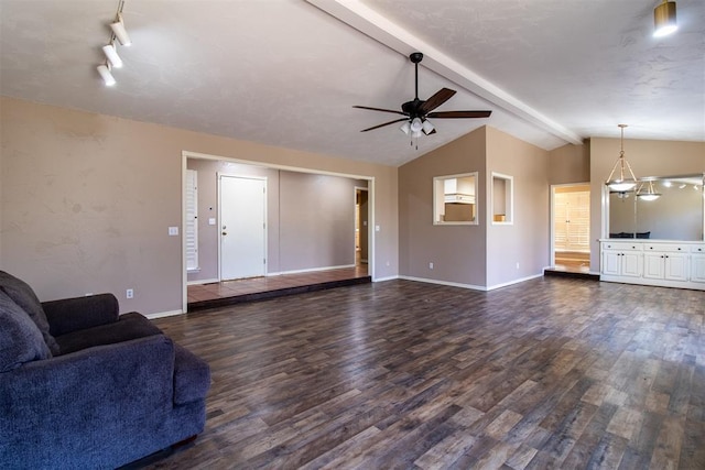 unfurnished living room featuring baseboards, ceiling fan, lofted ceiling with beams, and dark wood finished floors