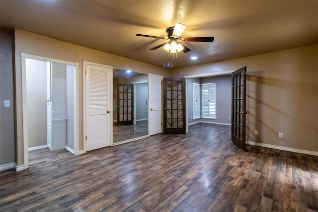 unfurnished bedroom featuring french doors, baseboards, dark wood finished floors, and ceiling fan