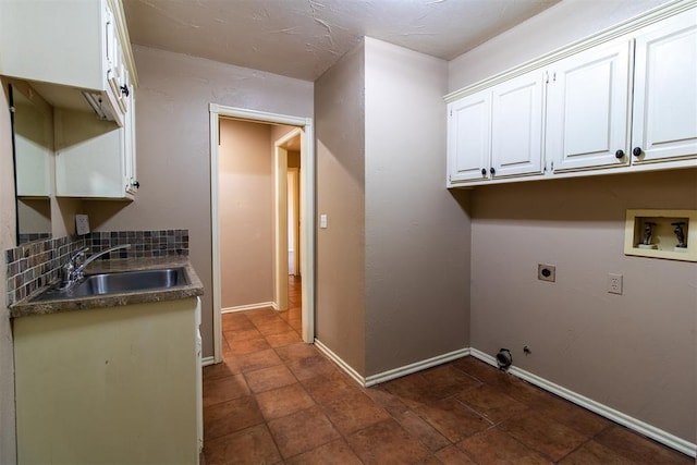 washroom with gas dryer hookup, hookup for an electric dryer, a sink, cabinet space, and washer hookup