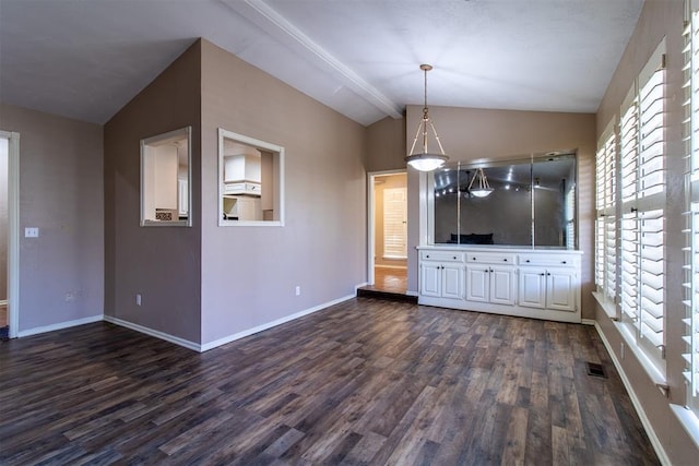 unfurnished living room with dark wood-type flooring, baseboards, vaulted ceiling, and visible vents