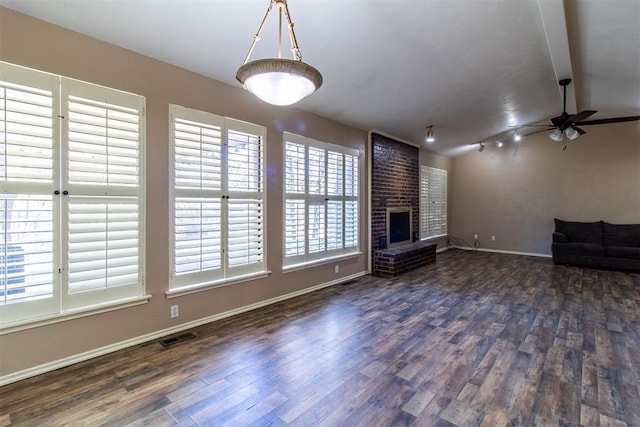 unfurnished living room with baseboards, ceiling fan, a fireplace, and dark wood-style flooring