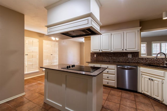 kitchen featuring decorative backsplash, stainless steel dishwasher, a sink, black electric stovetop, and custom range hood