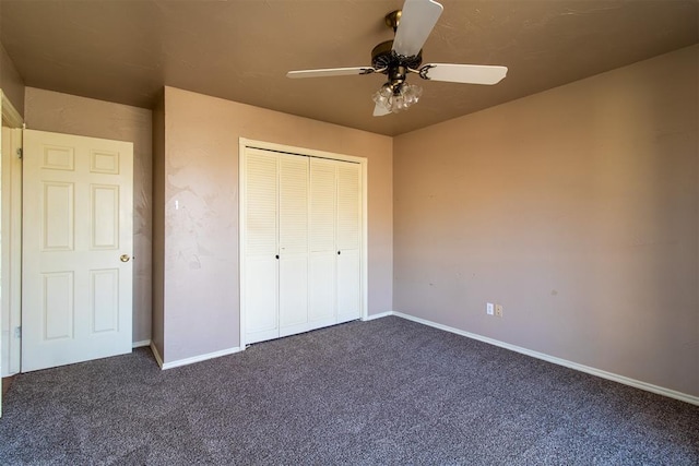 unfurnished bedroom with baseboards, a closet, and dark carpet