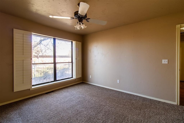 spare room featuring baseboards, carpet, and ceiling fan