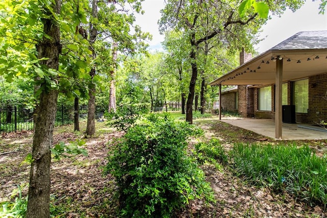 view of yard with a patio and fence