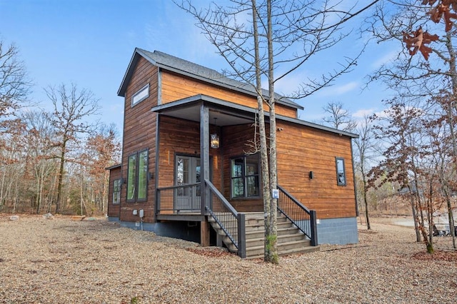 contemporary house featuring a porch and crawl space