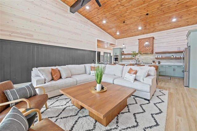 living area with wood walls, high vaulted ceiling, recessed lighting, wood ceiling, and light wood finished floors
