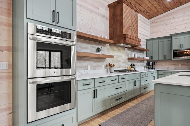 kitchen with open shelves, wood walls, stainless steel appliances, decorative backsplash, and wooden ceiling