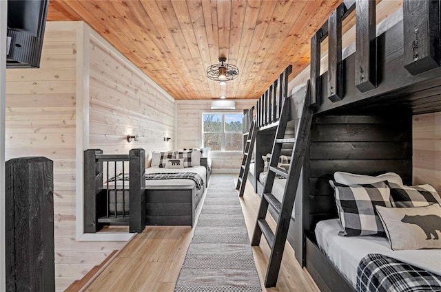 bedroom featuring wooden walls, wood ceiling, and wood finished floors