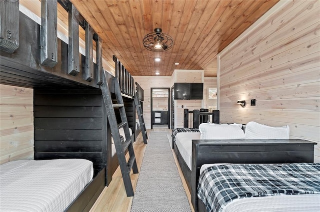 bedroom featuring recessed lighting, wood walls, light wood finished floors, and wooden ceiling