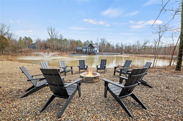 exterior space featuring a water view and an outdoor fire pit