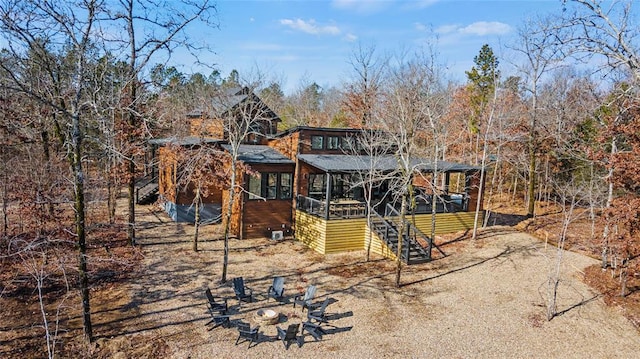 rear view of property featuring a deck