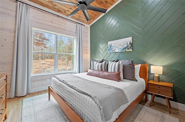 450 Whomping Willow Way, Broken Bow, OK 74728 - bedroom featuring wooden walls, light wood-style flooring, and wooden ceiling