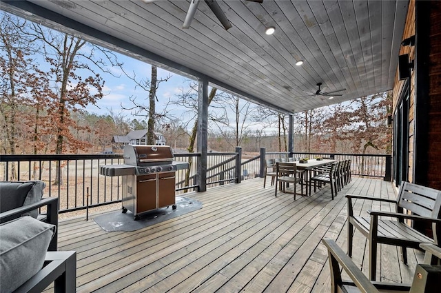 450 Whomping Willow Way, Broken Bow, OK 74728 - wooden terrace with a ceiling fan, a grill, and outdoor dining space