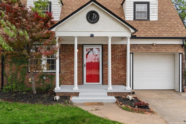 view of front of house featuring brick siding, a shingled roof, an attached garage, and concrete driveway