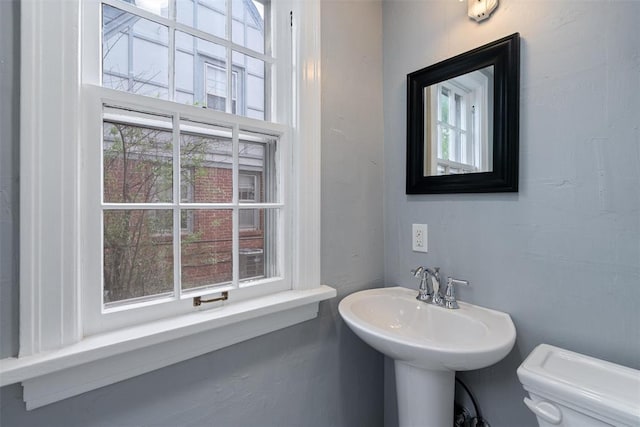 half bath featuring a sink and toilet