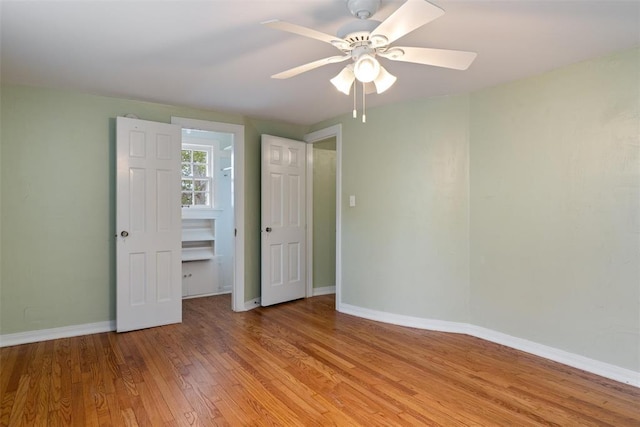 unfurnished bedroom with baseboards, ceiling fan, and light wood-type flooring