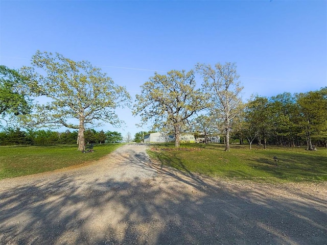 view of street with gravel driveway