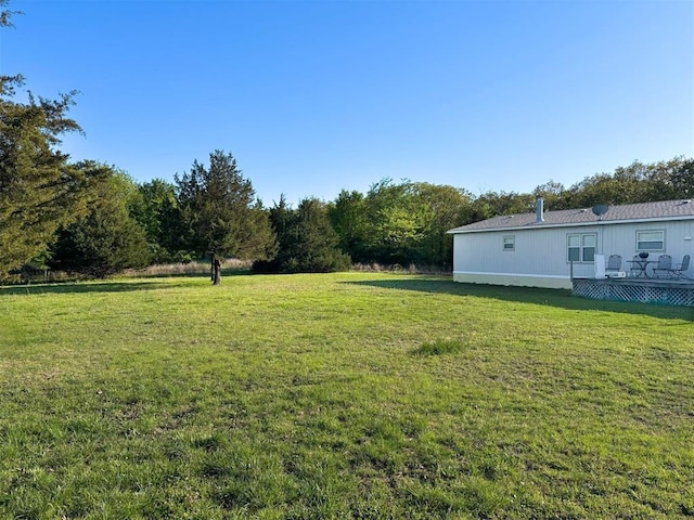 view of yard featuring a wooden deck
