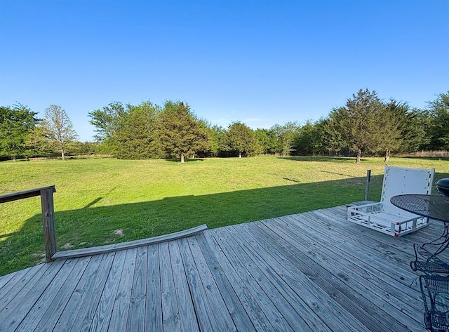 wooden terrace featuring a yard