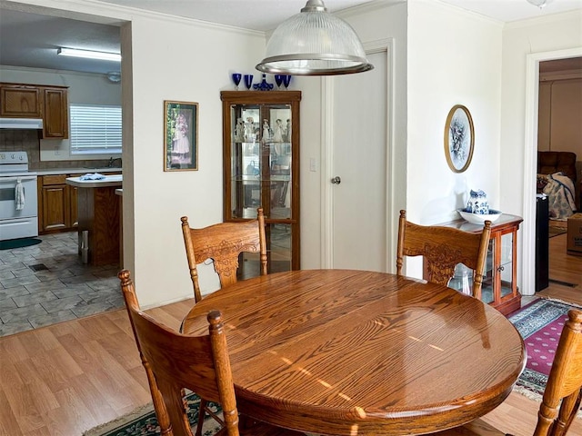 dining area featuring crown molding and wood finished floors
