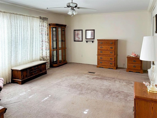 interior space with ceiling fan, crown molding, and visible vents