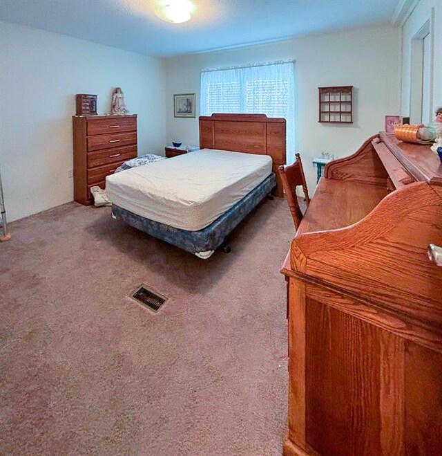 bedroom featuring carpet floors and visible vents