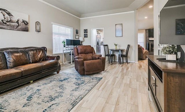716 SW 149th Pl, Oklahoma City, OK 73170 - living area featuring baseboards, ornamental molding, light wood finished floors, and plenty of natural light