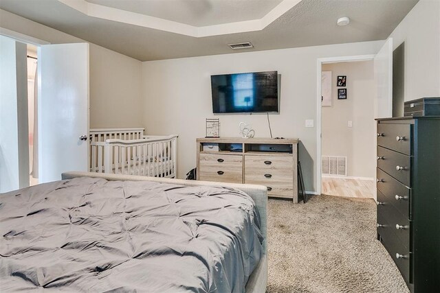 716 SW 149th Pl, Oklahoma City, OK 73170 - bedroom with a raised ceiling, visible vents, carpet flooring, and baseboards