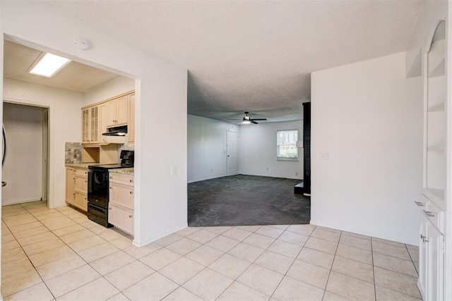 interior space featuring black / electric stove, a ceiling fan, light colored carpet, light countertops, and under cabinet range hood