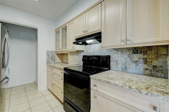 kitchen with light tile patterned floors, decorative backsplash, under cabinet range hood, and black range with electric cooktop