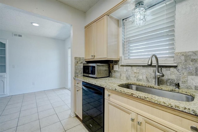 kitchen with visible vents, decorative backsplash, stainless steel microwave, a sink, and dishwasher