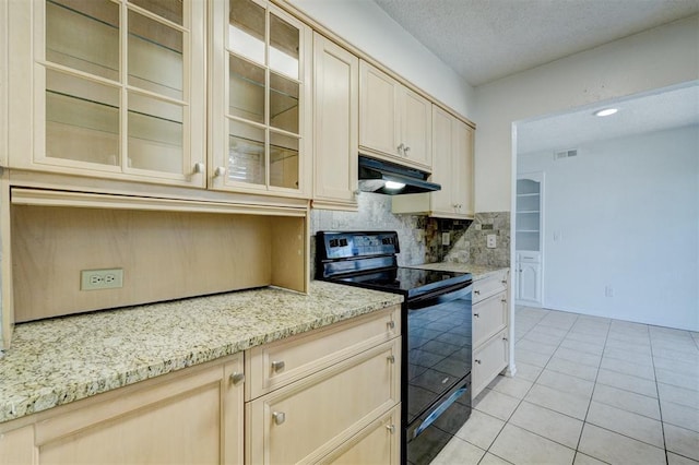 kitchen featuring light tile patterned floors, black / electric stove, tasteful backsplash, under cabinet range hood, and visible vents