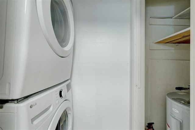 washroom with stacked washing maching and dryer and laundry area