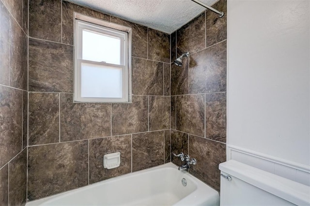 bathroom featuring a textured ceiling, toilet, and  shower combination