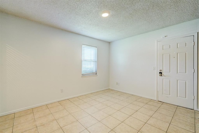 empty room with baseboards, recessed lighting, and a textured ceiling