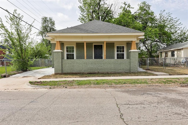1608 NE 21st St, Oklahoma City, OK 73111 - view of front of house with brick siding, fence, and a porch