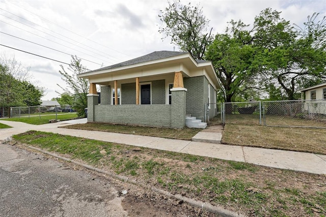 1608 NE 21st St, Oklahoma City, OK 73111 - bungalow-style home featuring fence, covered porch, brick siding, and a gate