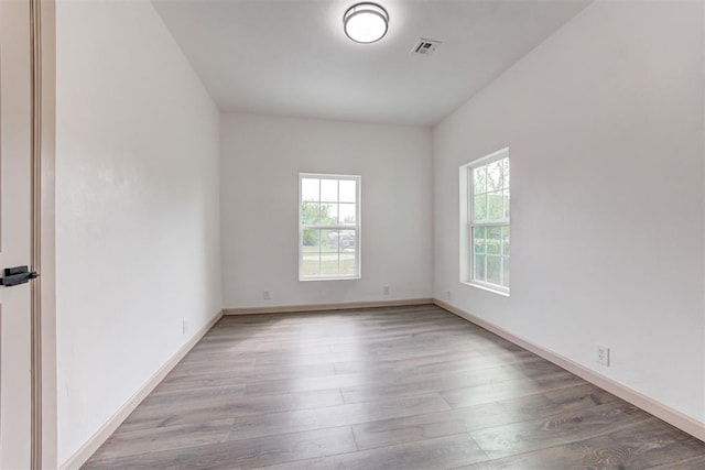 1608 NE 21st St, Oklahoma City, OK 73111 - unfurnished room featuring visible vents, baseboards, and wood finished floors