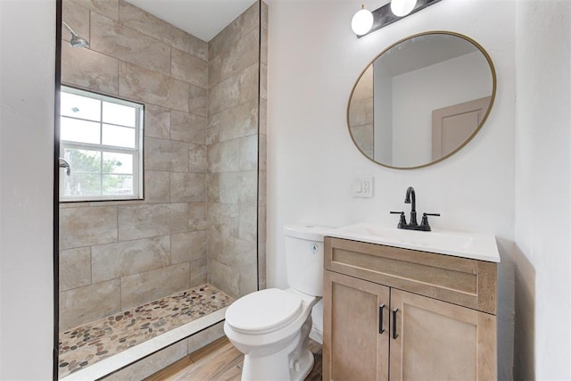 1608 NE 21st St, Oklahoma City, OK 73111 - full bath with toilet, vanity, wood finished floors, and tiled shower