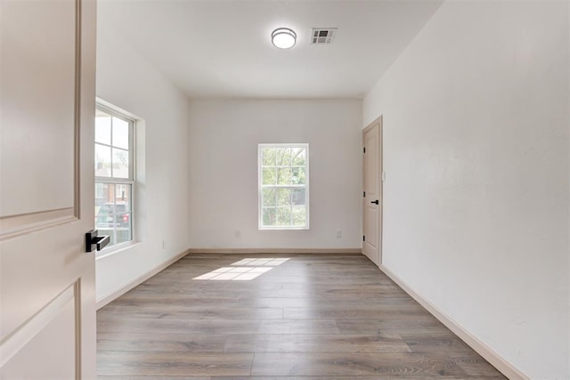 1608 NE 21st St, Oklahoma City, OK 73111 - unfurnished room with wood finished floors, visible vents, and baseboards