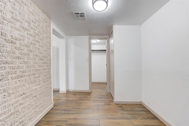 1608 NE 21st St, Oklahoma City, OK 73111 - corridor with brick wall, baseboards, and wood finished floors