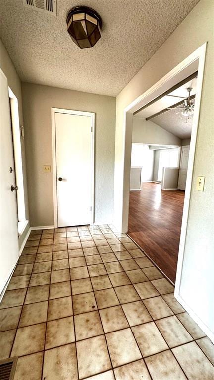 2900 Pheasant Run, Edmond, OK 73012 - hallway featuring a textured ceiling and vaulted ceiling