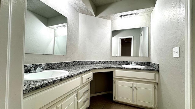 2900 Pheasant Run, Edmond, OK 73012 - full bathroom with double vanity, tile patterned floors, and a textured wall