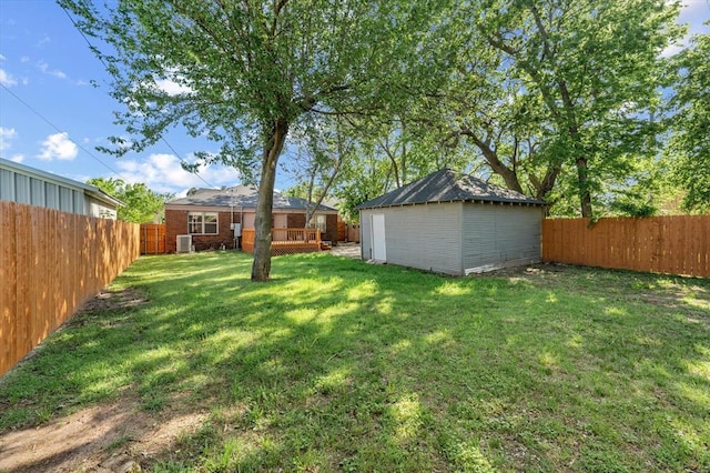 view of yard featuring a fenced backyard, a shed, and an outdoor structure